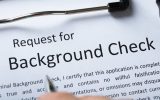 Close up of a sheet of paper with the words "Request for Background Check" across the top in big letters.