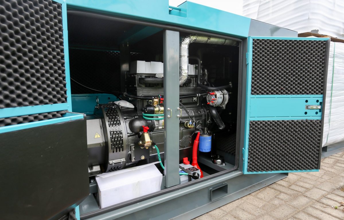 An industrial diesel generator. The front panel of the generator is open and you can see the various components inside.