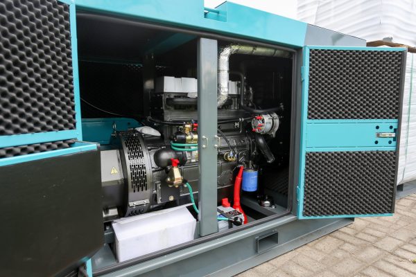 An industrial diesel generator. The front panel of the generator is open and you can see the various components inside.